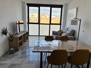 a living room with a table and chairs and a couch at Alojamientos CASTILLA-AGAVE in Tabernas