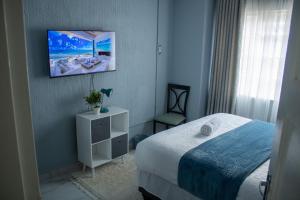 Rehoboth Ezulwini Suites客房内的一张或多张床位