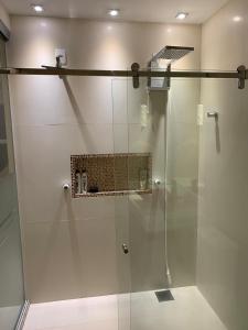 a shower with a glass door in a bathroom at Apartamento Duplex Cobertura in Belém