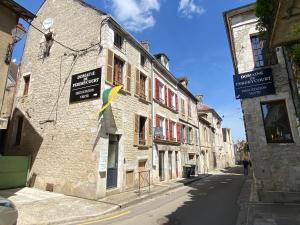 a building with signs on the side of a street at La Belle vigne - Chablis Centre in Chablis