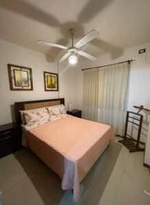 a bedroom with a bed and a ceiling fan at SORRENTO Céntrico con cochera in Villa Carlos Paz