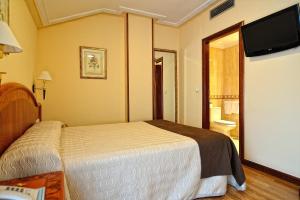 Postel nebo postele na pokoji v ubytování Hotel Alisi