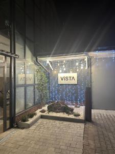 a visa sign on the side of a building with lights at Vista premium apart in Choszczówka