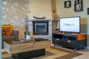 a living room with a flat screen tv and a couch at Cozy and Quiet Spacious Flat in Vila Nova de Gaia