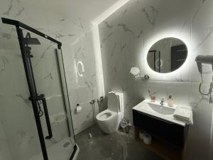 a bathroom with a toilet and a sink and a mirror at Vrbecká restaurace-penzion 7 in Hrubá Vrbka