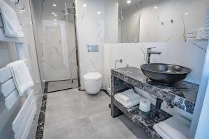 a bathroom with a sink and a toilet at Prawdzic Family Resort & Wellness in Gdańsk
