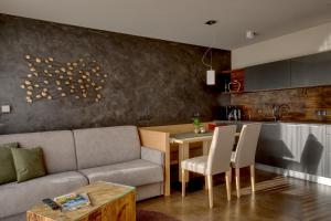 a living room with a couch and a table at Landhaus Freiburgerhof in Rifiano
