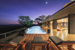 a deck with benches and a swimming pool on a house at Serengeti Explorer in Serengeti National Park