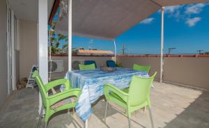a table and chairs on the balcony of a house at Anadiomeni Pool & Beach Apartments by "elite" in Zakynthos