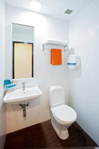 a bathroom with a toilet and a sink at Hotel 81 Fuji in Singapore