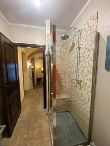 a bathroom with a shower with a glass door at La Lanterna in Collesalvetti