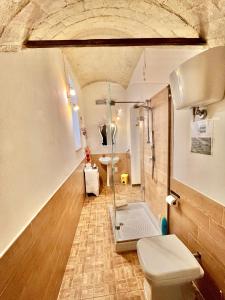 a bathroom with a shower and a toilet at Spello Vacanze Dante's House piano terra in Spello +58 photos