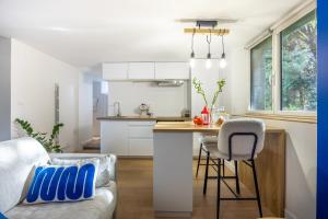 a kitchen and living room with a couch and a table at Gîtes de la vicomté in Dinard
