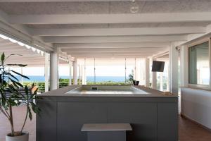 a large bath tub in the middle of a room at Le Secche Suite & House 2 by Salento Prime in Torre Pali 