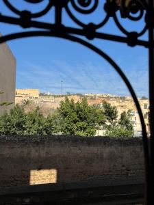 a view of a city from an iron gate at Appartement khmissa in Fès al Bali