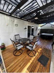 a patio with a table and chairs on a wooden deck at Villa Horizonte in Plazuela