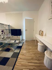 a living room with a glass table and a couch at Apartment city centrum in Nitra