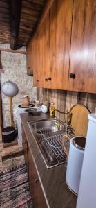 a kitchen with a sink and a stove top oven at Angels Traditional House in Arminou