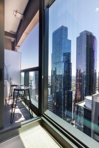 an office window with a view of the city at Stunning Top Floor City Views 2BR Gem, Central CBD in Melbourne