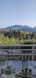 a table with two cups on top of a balcony at Loukas House 1Σταυρος-Κερκυρα Μακράτα in Stavrós