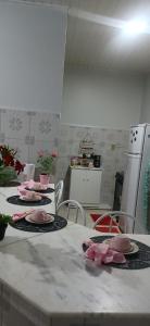 a kitchen with a table with plates of food on it at Apartamento mobiliado no centro, Siqueira Campos, in Santarém
