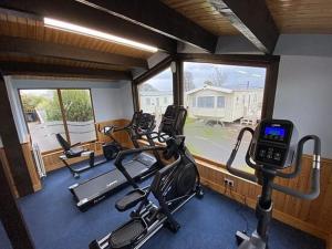 a gym with several exercise bikes and a cell phone at Daisy's Haven - Endless Pool, Tennis, Sky TV in Port Carlisle