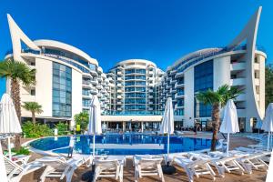 a hotel with a swimming pool in front of a building at Hotel Zenith in Sunny Beach