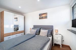 a bedroom with a bed and a mirror at Schorsch's Ferienhaus in Winzeln