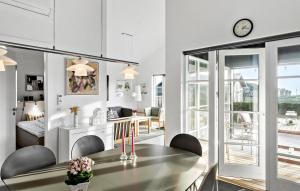 a kitchen and living room with a table and chairs at Cozy Home In Nysted With Sauna in Nysted