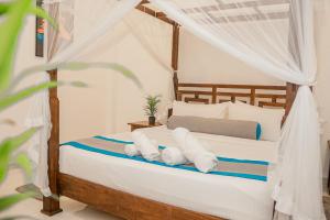 a bedroom with a canopy bed with white pillows at Ella Soul Resort in Ella +100 photos