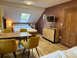 a room with two beds and a table and chairs at Ubytování pod lípou in Pulice