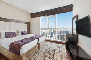 DAMAC Maison Distinction客房内的一张或多张床位