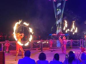 a group of people watching a circus show with fire performers at Vidanta Nuevo Vallarta Grand Luxxe 3 Bedroom Spa in Nuevo Vallarta 