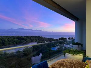 a room with a balcony with a view of a river at Vidanta Nuevo Vallarta Grand Luxxe 3 Bedroom Spa in Nuevo Vallarta 