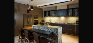 a kitchen with a table and some chairs in it at Vidanta Nuevo Vallarta Grand Luxxe 3 Bedroom Spa in Nuevo Vallarta 