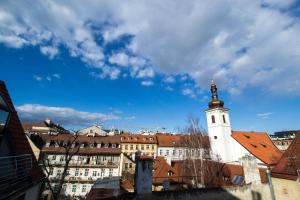 a building with a clock tower in a city at National Theater Ruterra Flat in Prague