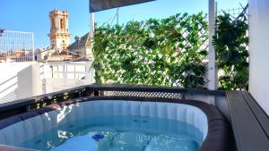 a swimming pool on the roof of a building at Boutike Apartments in Seville +18 photos