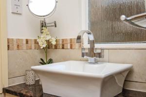 a white sink in a bathroom with a mirror at Pudding Cottage in Bakewell in Bakewell +17 photos