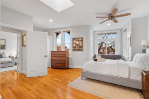 a white bedroom with a bed and a ceiling fan at Spacious and Central DC 3-BR Getaway Close to It All in Washington, D.C.
