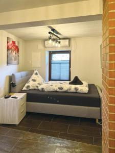 a bed in a room with a couch and a window at Nicole in Quedlinburg