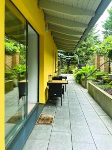 a patio with tables and chairs and a yellow wall at Nicole II in Quedlinburg +16 photos