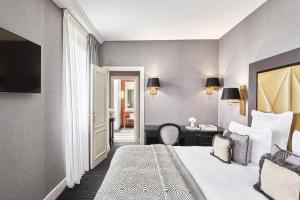 a hotel room with a bed and a desk at Hôtel Barrière Le Majestic Cannes in Cannes