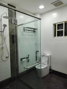 a bathroom with a glass shower and a toilet at KLANG - Enjoy Life Klang Homestay in Klang +13 photos