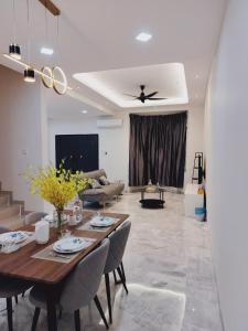 a living room with a table and a couch at KLANG - Enjoy Life Klang Homestay in Klang