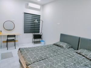 a bedroom with a bed and a table and a window at KLANG - Enjoy Life Klang Homestay in Klang