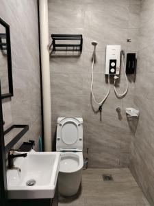 a bathroom with a toilet and a sink at KLANG - Enjoy Life Klang Homestay in Klang