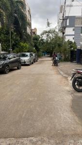 a street with cars parked on the side of the road at Z-One Serviced Apartment in Hyderabad