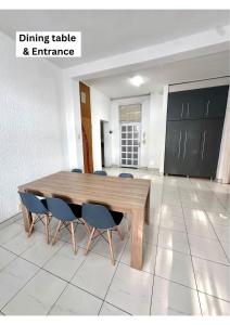a wooden table and chairs in a room at Beach Hurst in Durban