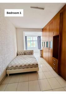 a bedroom with a bed and a window at Beach Hurst in Durban