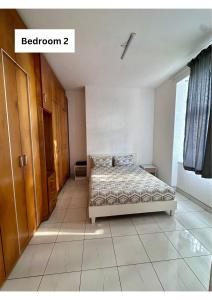 a bedroom with a bed in the middle of a room at Beach Hurst in Durban +14 photos
